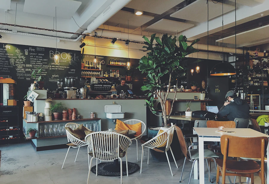 Industrial cafe with chalkboard menu and laptop user