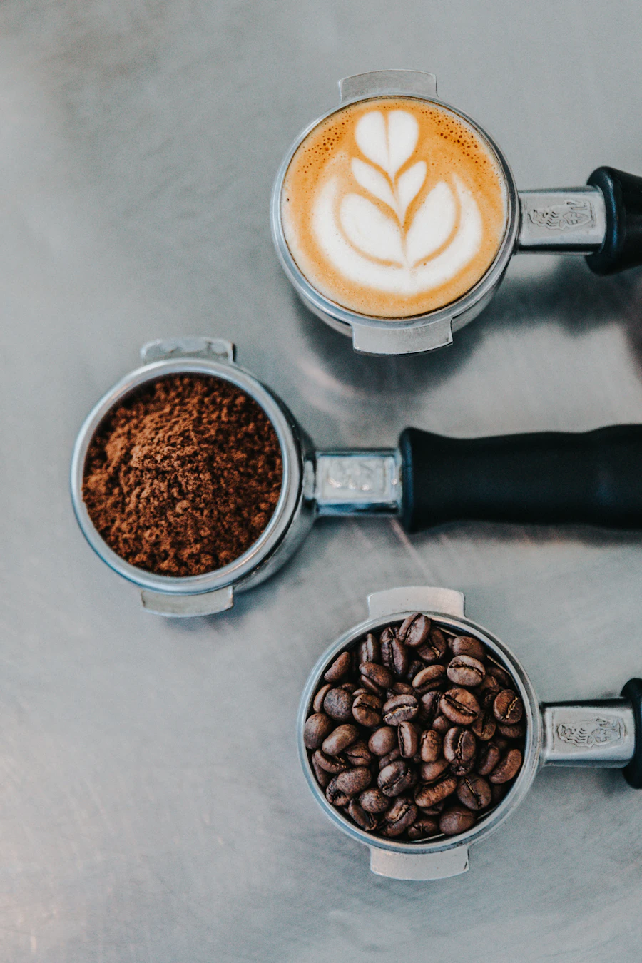 Espresso portafilters with coffee beans and latte art