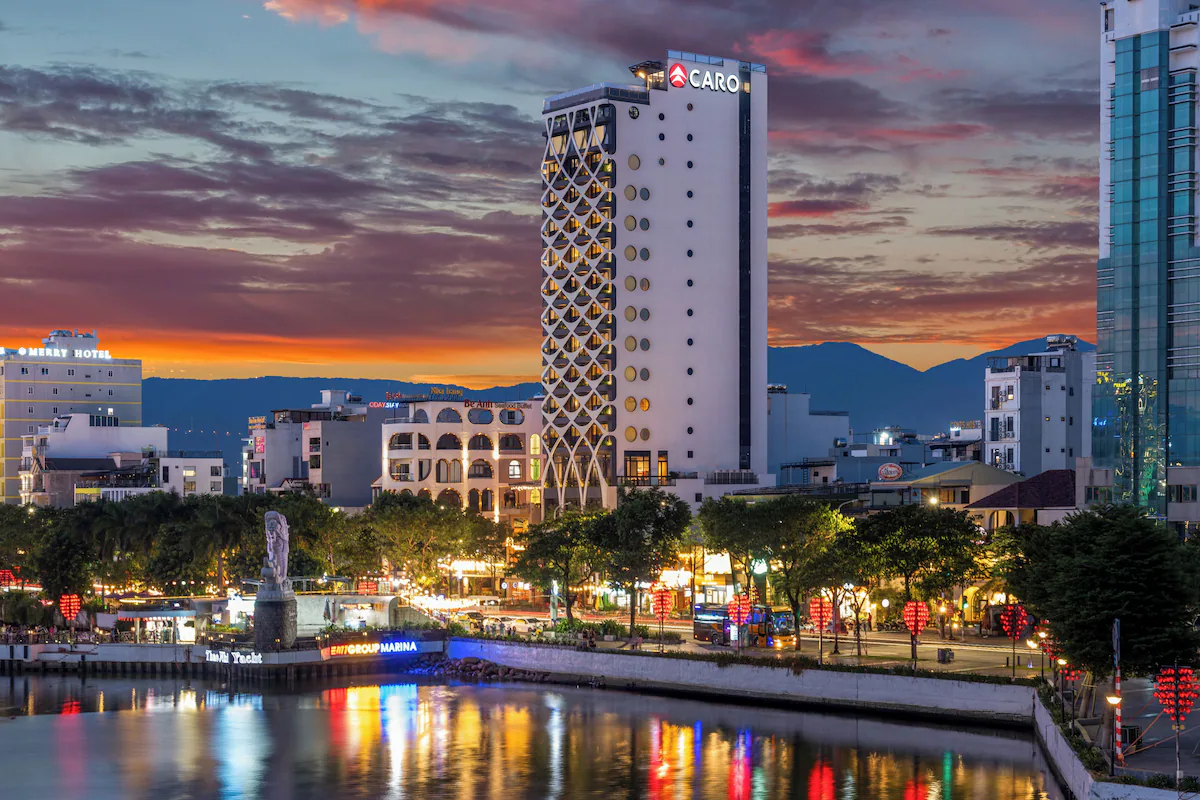 Caro Hotel Da Nang exterior at sunset on Han River promenade