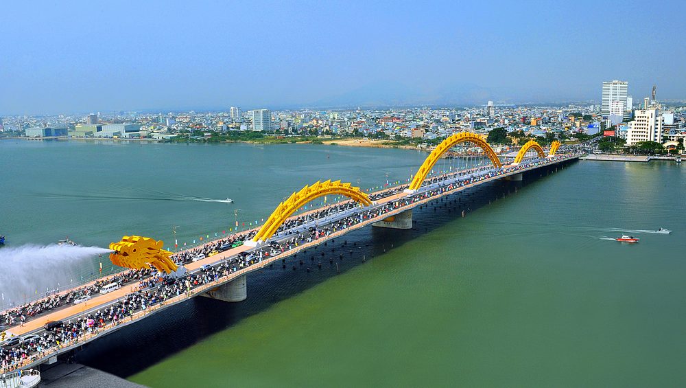 Dragon Bridge Da Nang over the Han River with city skyline in background