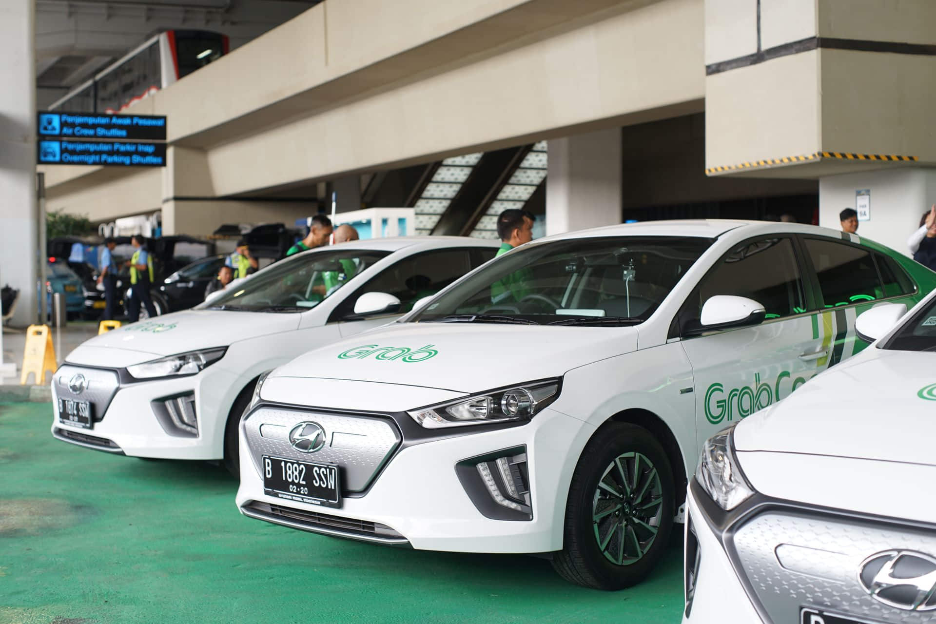 GrabCar fleet parked at airport pickup zone