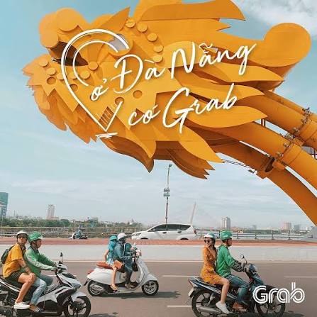 Grab riders passing Dragon Bridge in Da Nang