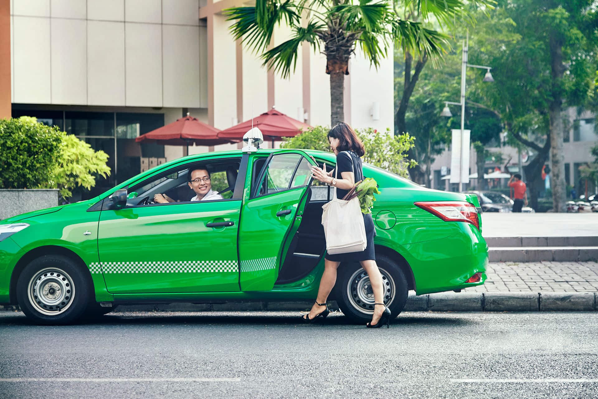 GrabCar green taxi Vietnam street pickup