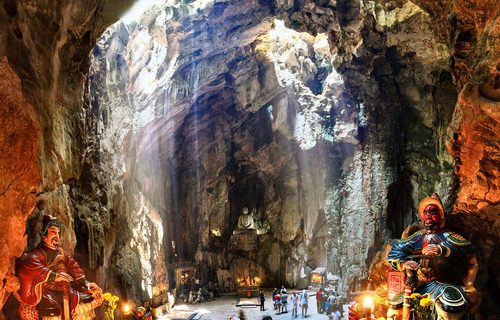 Marble Mountains Da Nang cave interior with light shafts and Buddha shrines