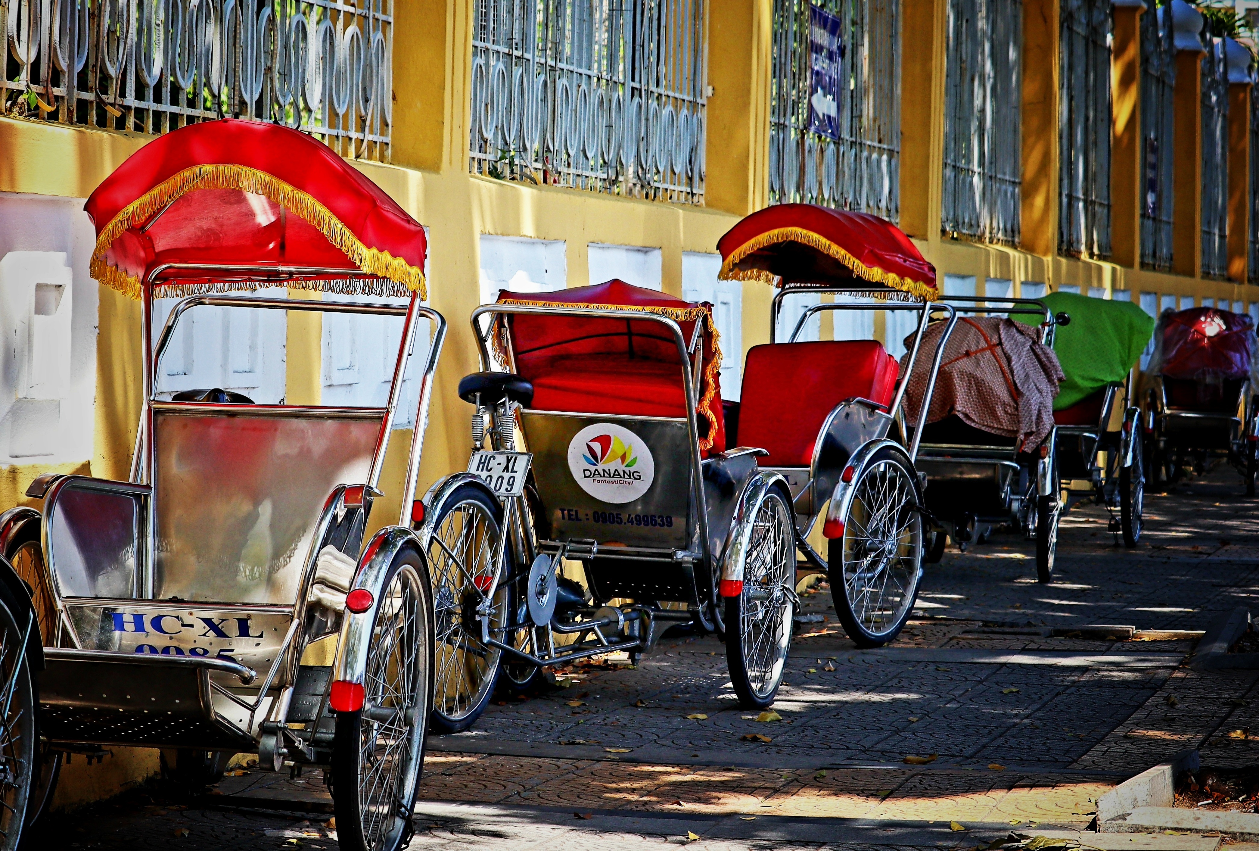 Cyclo rickshaws and transport on a Da Nang city street