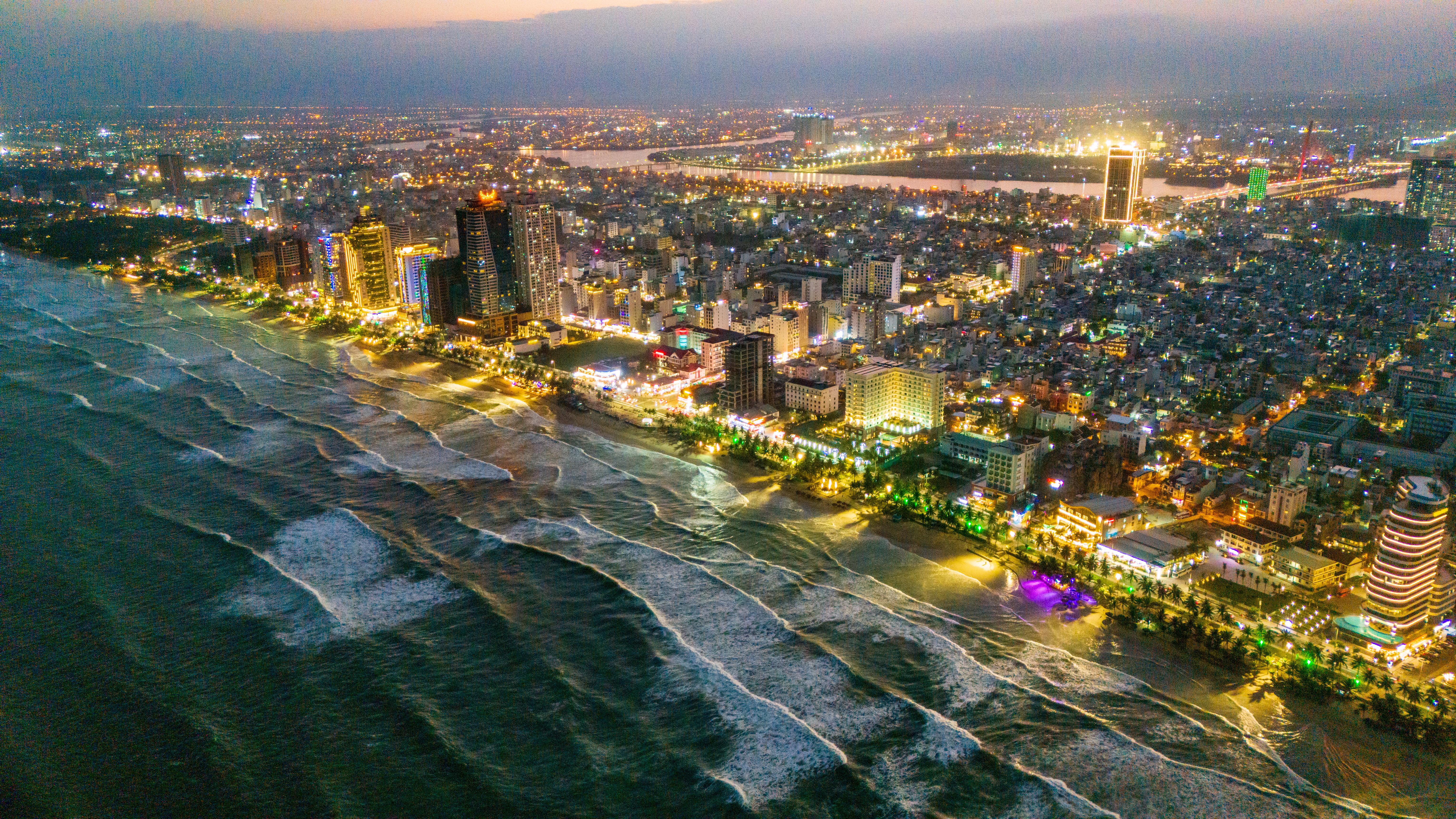 Da Nang beach and city at night from aerial view