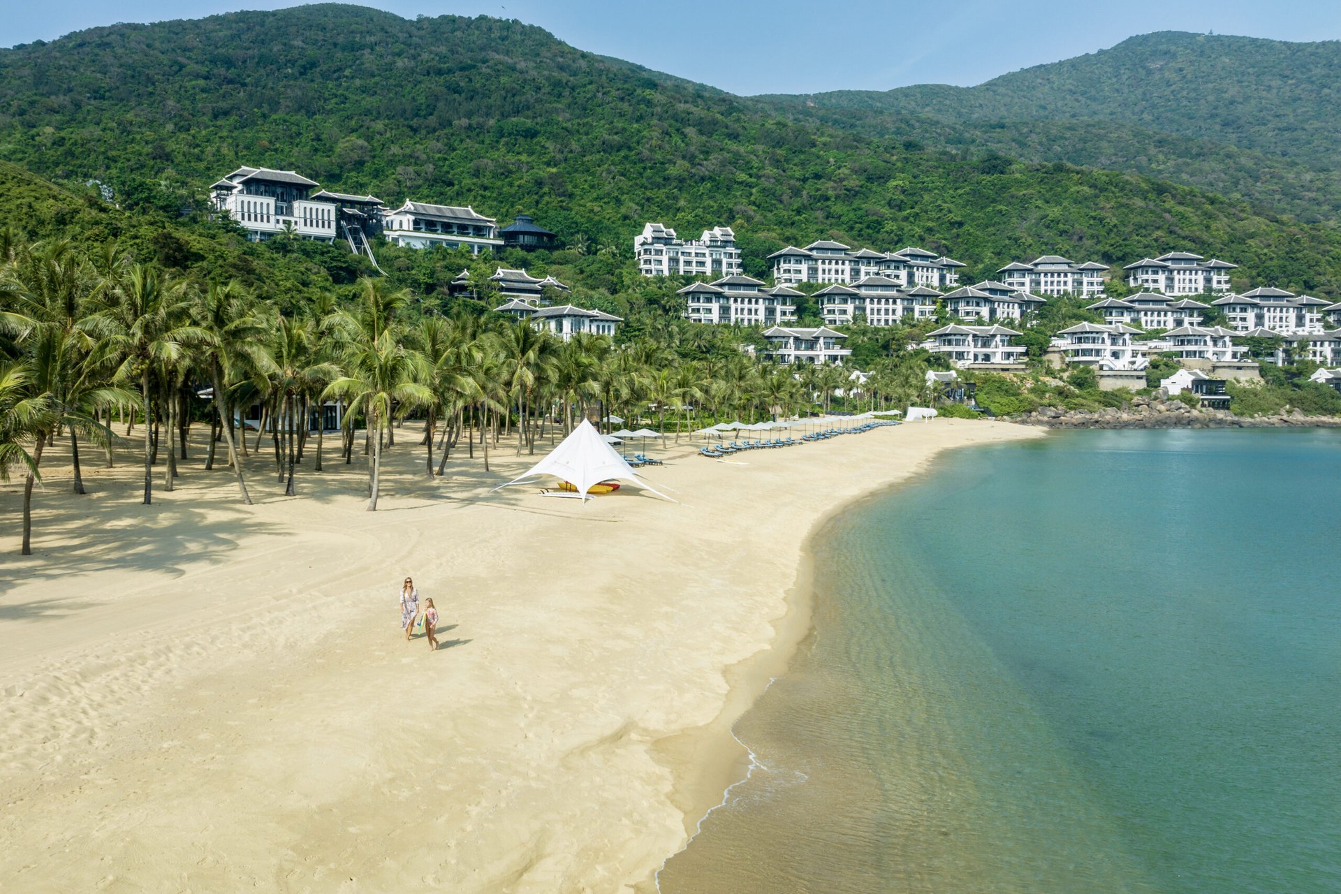 InterContinental Danang Sun Peninsula Resort — private beach cove and resort cascading down jungle hillside