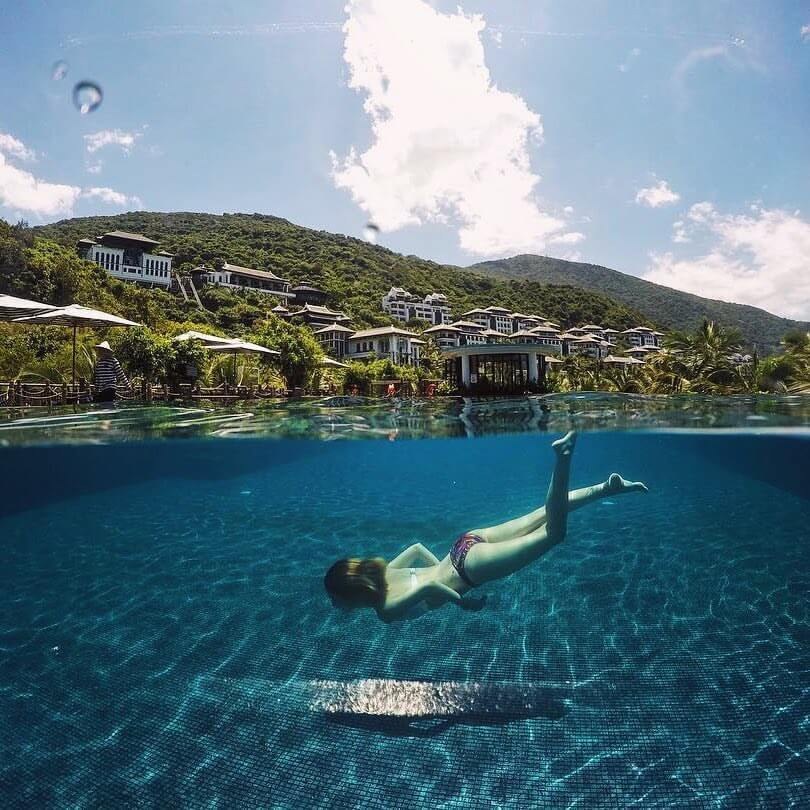 InterContinental Danang Sun Peninsula Resort infinity pool with resort and Son Tra hillside behind