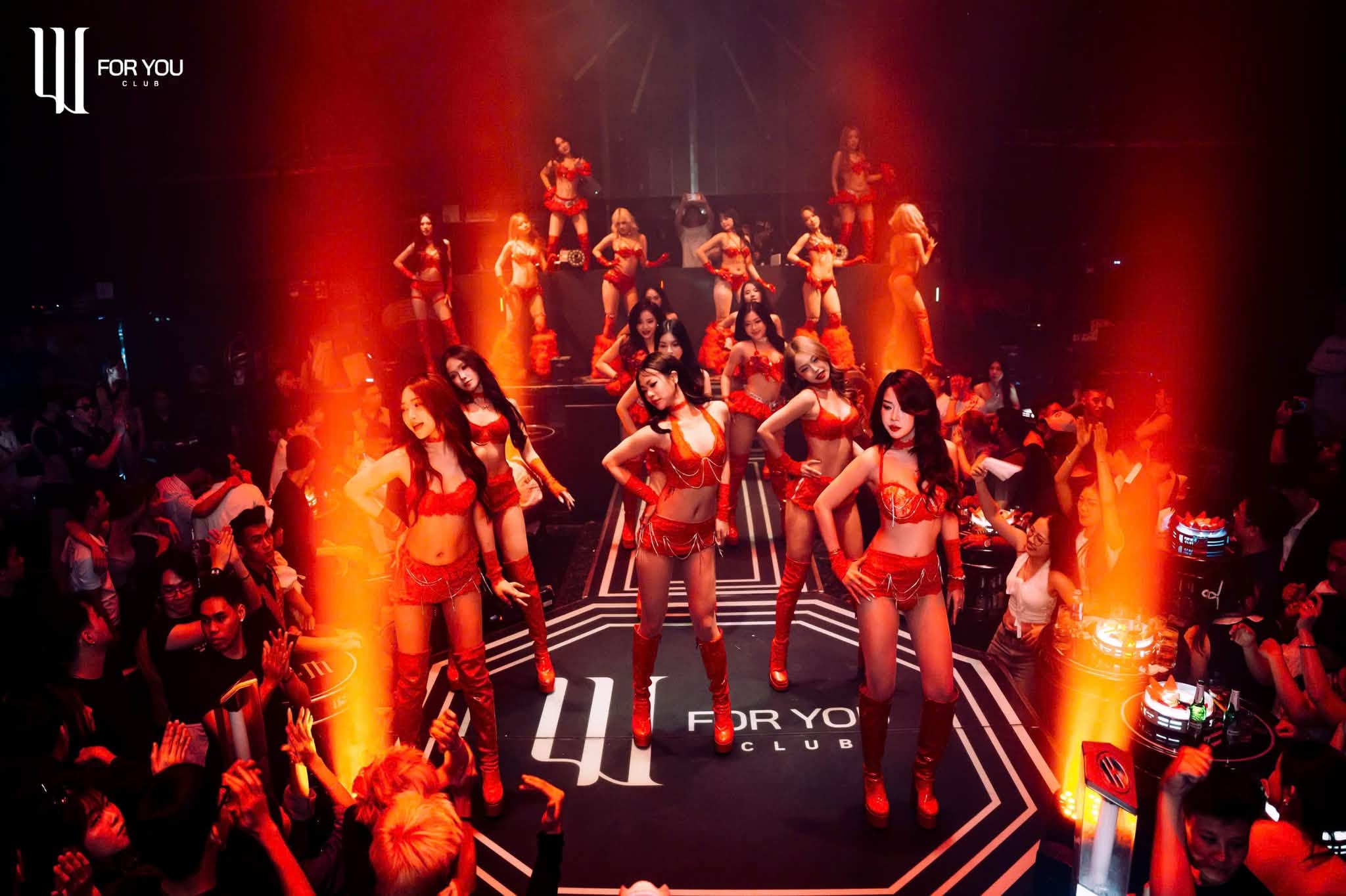 For You Club Da Nang, dancers on stage with orange pyrotechnics and packed crowd