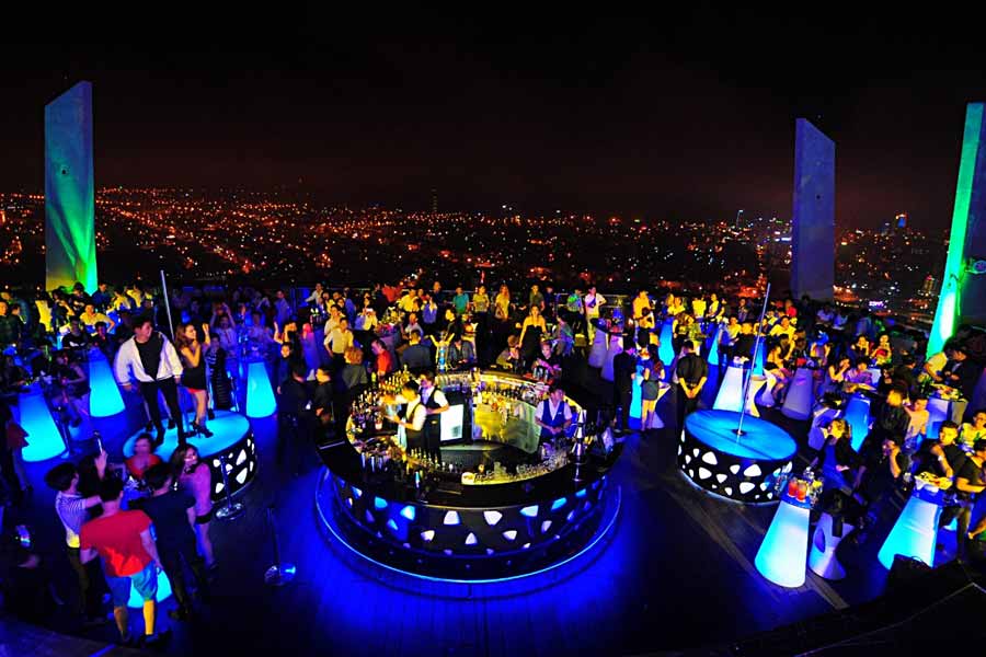 Sky36 Da Nang rooftop bar at night — packed open-air terrace with city lights panorama
